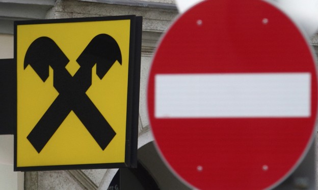 A Raiffeisen bank logo is pictured next to a traffic sign in Vienna